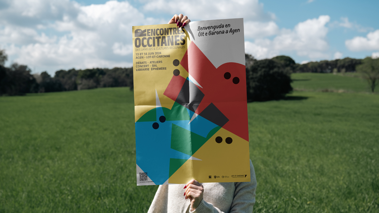 Affiche des Rencontres occitanes présentée dans un paysage